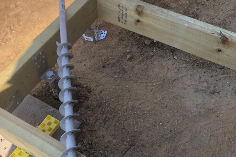 Foundation frame with attached and detached screw pile.