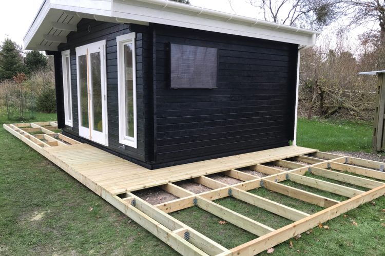 Garden shed with a wooden deck in the making.
